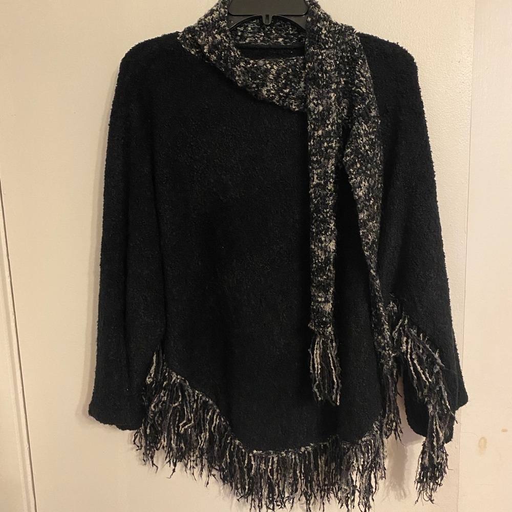 Soft acrylic poncho. Black with black, grey and white fringe.